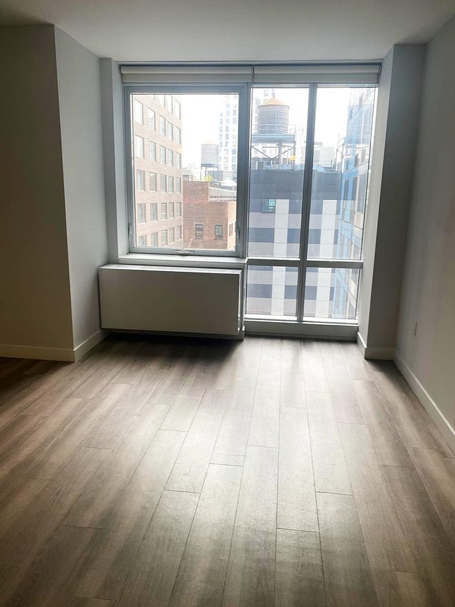 The other end of the same living area, windows and clean floor